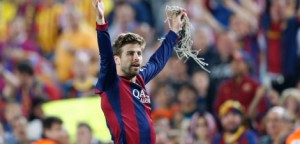 Barcelona's Gerard Pique carries a piece of the goal net celebrating after winning the final of the Copa del Rey soccer match between FC Barcelona and Athletic Bilbao at the Camp Nou stadium in Barcelona, Spain, Saturday, May 30, 2015. (AP Photo/Manu Fernandez)