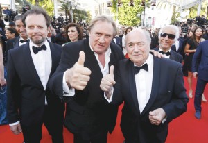 Actor Gerard Depardieu (C), FIFA President Sepp Blatter (R) and director Frederic Auburtin pose on the red carpet for the screening of the film "United Passions" at the 67th Cannes Film Festival in Cannes, in this May 18, 2014 file photo.Sepp Blatter resigned as FIFA president on Tuesday in the face of a U.S.-led corruption investigation that has plunged world soccer's governing body into the worst crisis in its history.  REUTERS/Yves Herman/Files ATTENTION EDITORS - THIS PICTURE IS PART OF PACKAGE "SEPP BLATTER STEPS DOWN". TO FIND ALL 15 IMAGES SEARCH 'SEPP BLATTER'.