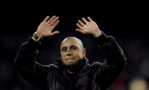 MADRID, SPAIN - FEBRUARY 12:  Former Real Madrid player Roberto Carlos waves to supporters after he was presented with a trophy for his achievements at the club by president Florentino Perez during the La Liga match between Real Madrid and Levante  at Estadio Santiago Bernabeu on February 12, 2012 in Madrid, Spain.  (Photo by Denis Doyle/Getty Images)