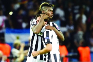 TOPSHOTS Juventus' midfielder Andrea Pirlo (R) and Juventus' French midfielder Paul Pogba reacts after the UEFA Champions League Final football match between Juventus and FC Barcelona at the Olympic Stadium in Berlin on June 6, 2015.  FC Barcelona won the match 1-3.   AFP PHOTO / OLIVIER MORIN