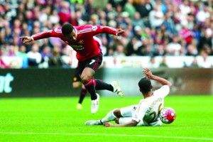 Swansea City's Kyle Naughton, right, competes for the ball with Manchester United's Memphis Depay during the English Premier League soccer match between Swansea City and Manchester United at the Liberty Stadium in Swansea, Wales, Sunday, Aug. 30, 2015.  (AP Photo/Matt Dunham)