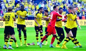 Dortmund's players celebrate after winning  the German Bundesliga soccer match between Borussia Dortmund and Hertha BSC Berlin in Dortmund, Germany, Sunday, Aug. 30, 2015. Dortmund defeated Berlin by 3-1. (AP Photo/Martin Meissner)