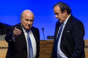 FIFA president Joseph Blatter (L) talks to UEFA president Michel Platini during the 64th FIFA congress on June 11, 2014 in Sao Paulo, on the eve of the opening match of the 2014 FIFA World Cup in Brazil.     AFP PHOTO / FABRICE COFFRINI